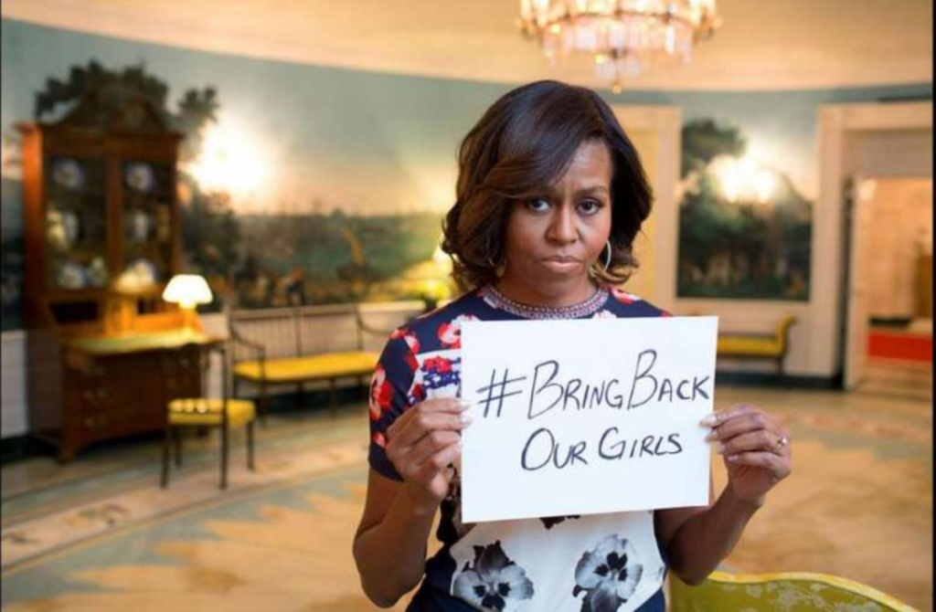 Michelle Obama holding a BBOG poster (CNN)