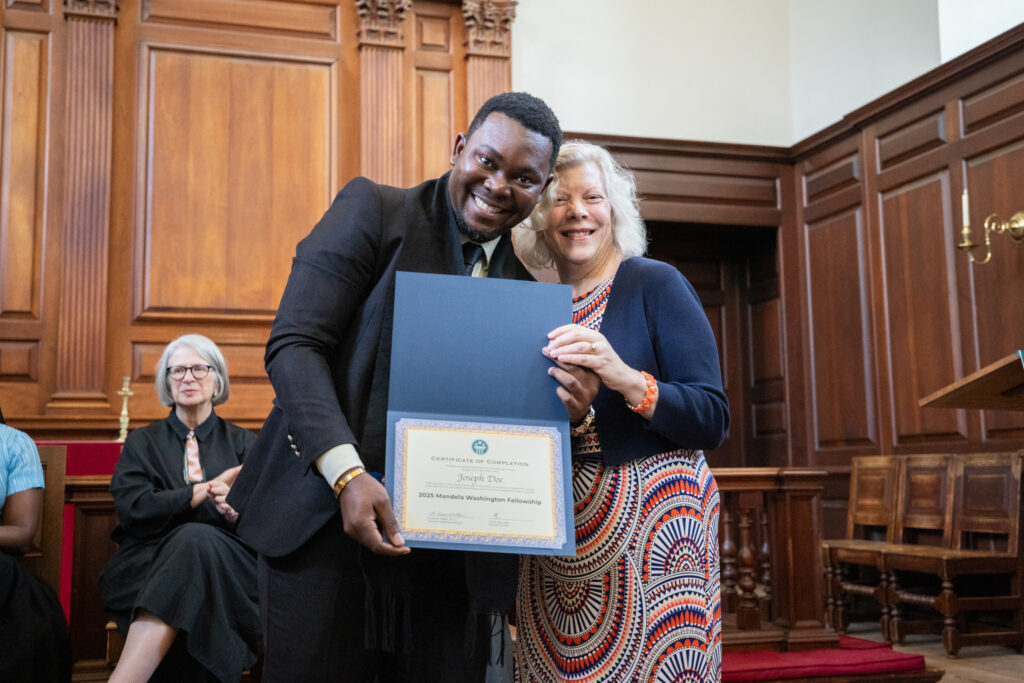Joseph receives his certificate of completion from Presidential Precinct Director of Programs Karen Walker