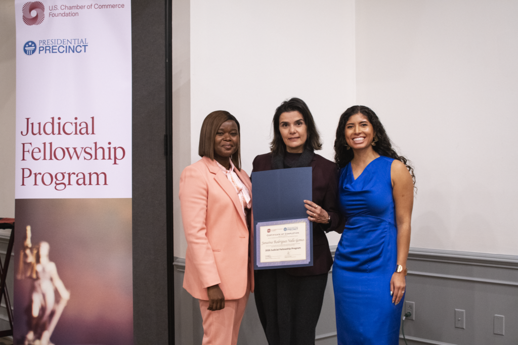 three women stand with a certificate from the judicial fellowship program