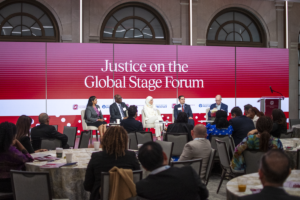 people speaking during a panel discussion called justice on the global stage forum